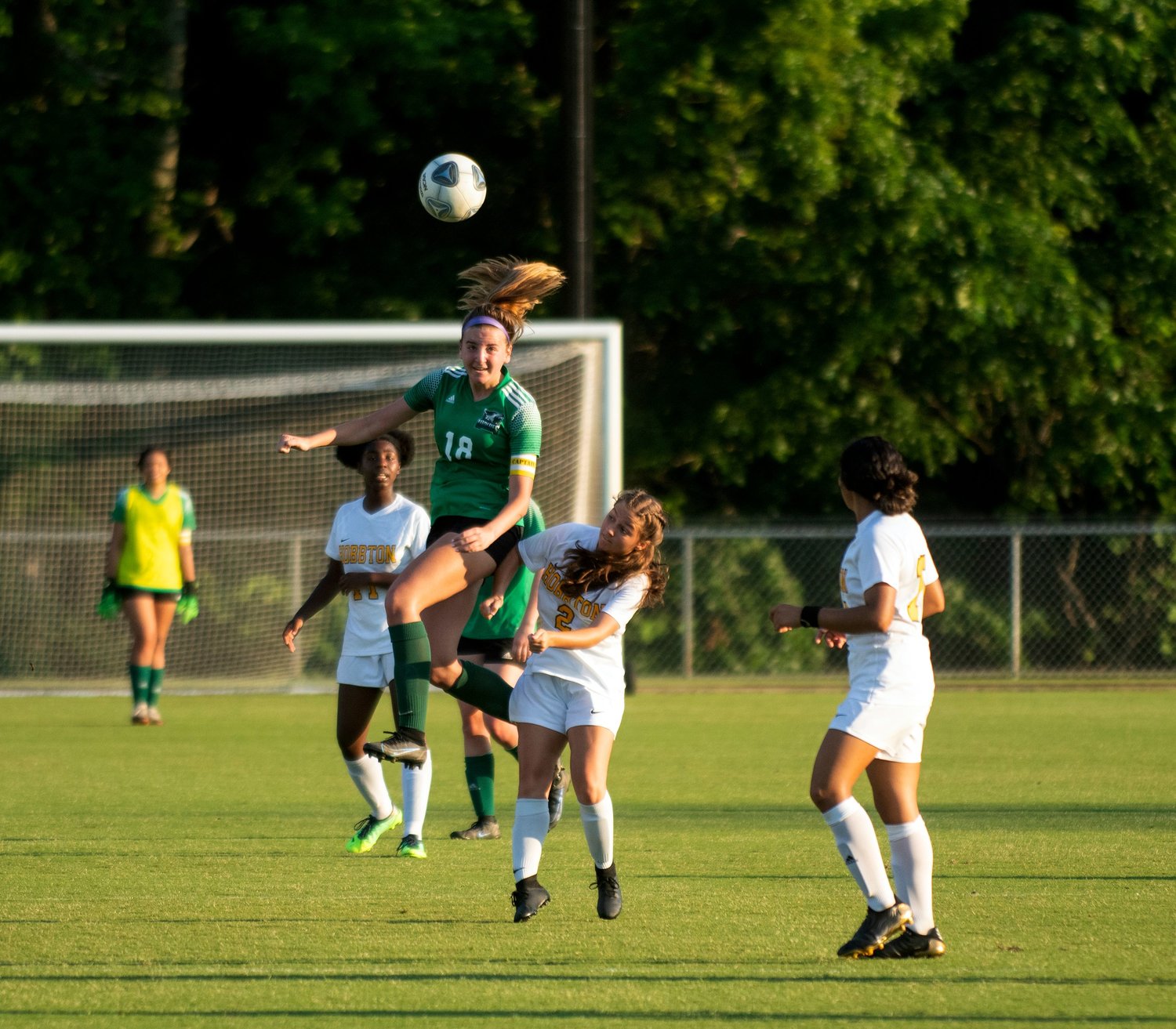 Woods Charter junior Lucy Miller (18) heads the ball during the Wolves' 5-0 win over the Hobbton Wildcats last Tuesday in Cary. Miller scored her lone goal in the win on a header off of a corner kick in the first half.